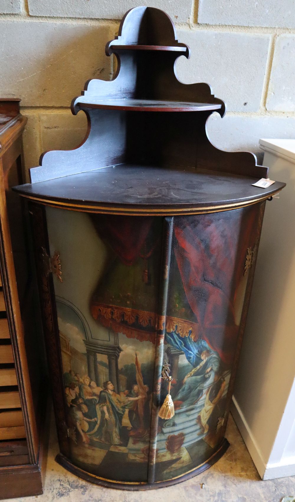 A Dutch painted and gilded hanging corner cupboard, circa 1800, width 57cm, depth 42cm, height 140cm